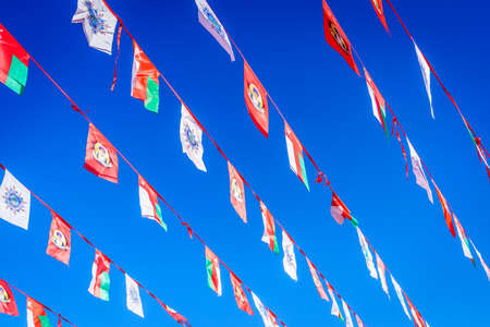 Nizwa, Oman, December 2, 2016: Festive Omani flags against clear blue skies over Friday Market in Nizwa, Omanのeditorial素材