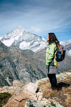 Young woman enjoying a view in the mountains near Swiss resort town of Zermattの写真素材