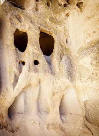 Natural cliff cavities expanded by ancestral puebloans at Bandelier National Monumentの写真素材