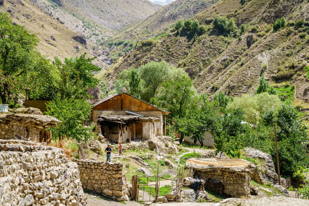 August 26, 2016, Margib village, Tajikistan: A young woman carries freshly baked traditional Tajik bread in a remote mountain village in Tajikistanのeditorial素材