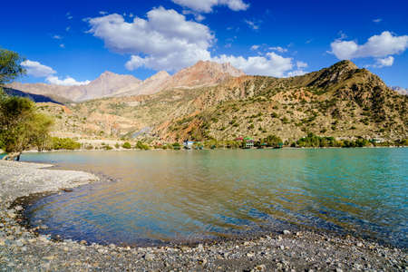 Scenic view of Iskanderkul - an alpine lake in the mountains of Tajikistanの写真素材