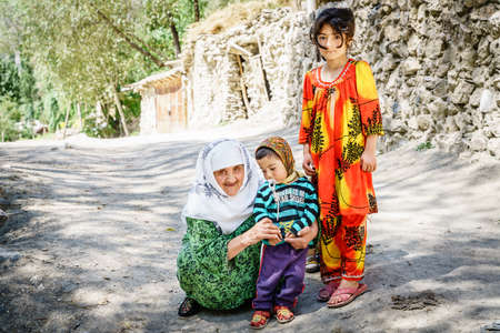 August 26, 2016, Margib village, Tajikistan: Local children with their grandmother in a small village in Yaghnob region of Tajikistanのeditorial素材