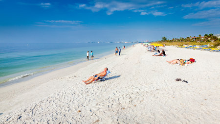 St Pete Beach, Florida, December 12, 2022: Vacationers are enjoying a beautiful sunny day at the beach on the Gulf coast of Floridaのeditorial素材