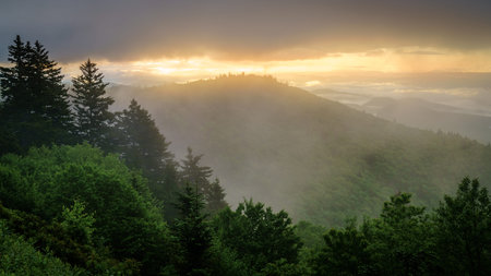 View of the Smokie Mountains from Blue Ridge Parkway with dramatic evening skies and fog rising from the valleys