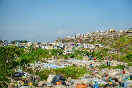 Lagos, Nigeria, November 22, 2019: People are living and picking through garbage at a waste disposal...