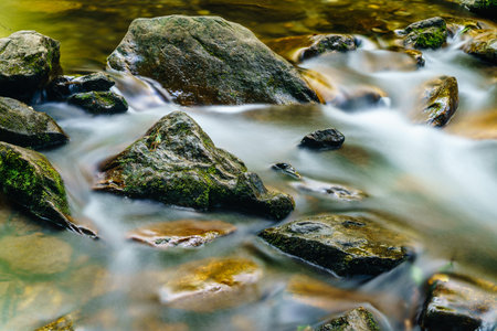 Long exposure image of water streaming around the rocks in a creek in North Carolina
