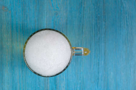 Mug of beer on blue wooden table top viewの写真素材