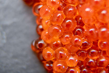 Red caviar close up on the grey stone backgroundの写真素材