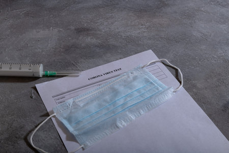 Protective medical mask and Coronavirus test paper form. Coronavirus concept. COVID-19の写真素材