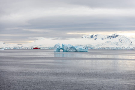 Expedition ship with iceberg in Antarctic sea