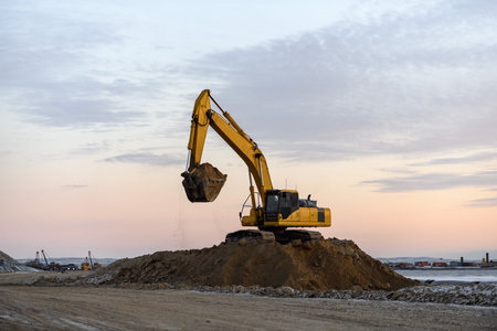 Yellow excavator working on construction site. The road construction.