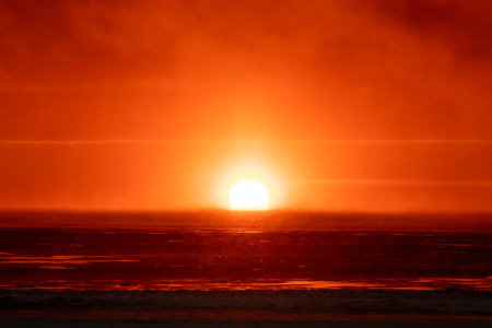 Beautiful sunset with fog in Arctic sea.