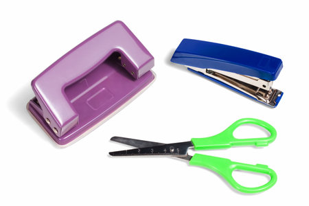 Office stationery, stapler, puncher and scissors isolated on white