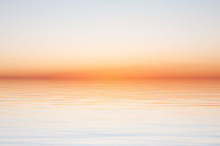 Clear morning sky over water surface with waves close-up view, simple beautiful sunrise or sunset...