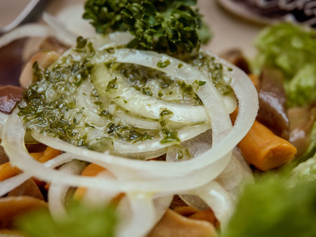 Marinated mushrooms in a salad, filled with oil and decorated with sliced onion rings.の写真素材