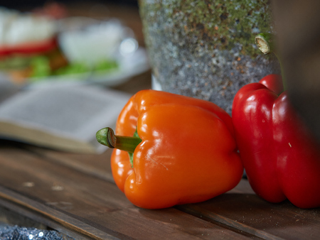 Two sweet bell peppers are next to each other on the table.の写真素材