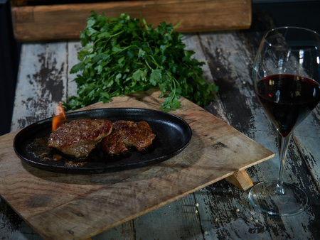 A portion of grilled beef is served on a tray and set on fire.の写真素材