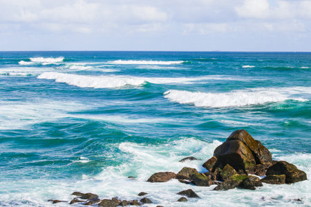 rocks close to the shore in waterの写真素材