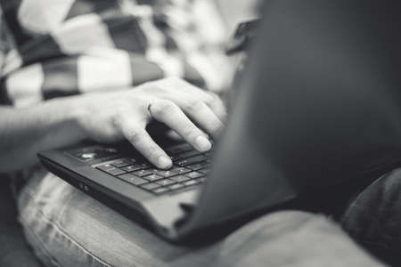 the man on the couch with a laptopの写真素材