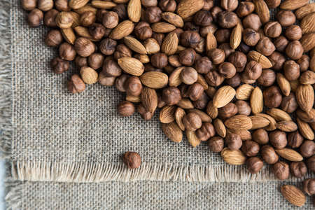scattering a pile of nuts on burlap clothの写真素材