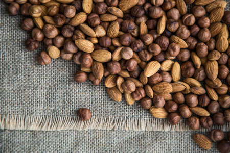 scattering a pile of nuts on burlap clothの写真素材