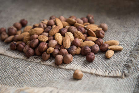 scattering a pile of nuts on burlap clothの写真素材