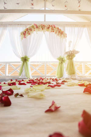 rose petals on the floor against the wedding arch.の写真素材