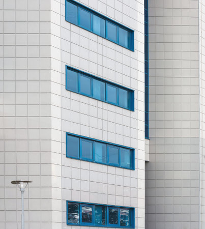 elements of the facade of a modern building made of blue glass and white decorationの写真素材