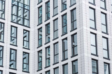 details of the facade of a modern skyscraper made of glass and steel closeup.の写真素材