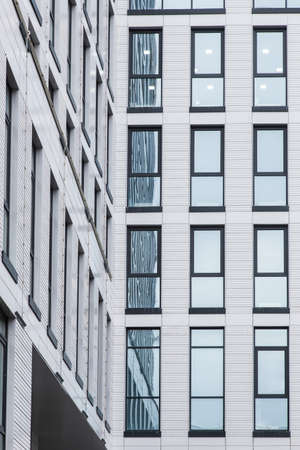 details of the facade of a modern skyscraper made of glass and steel closeup.の写真素材