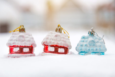 Toy snow-covered houses. Christmas tree toy. Red and brilliant blue houses. New Year.の写真素材