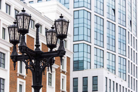 street black vintage lantern on a background of classical and modern urban architectureの写真素材