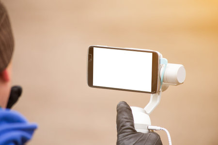 the person shoots on the phone with an electronic portable stabilizer. Close-up. screen smartphone...