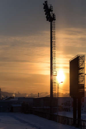 lighting towers mantles at the stadium on a sunset background.の写真素材