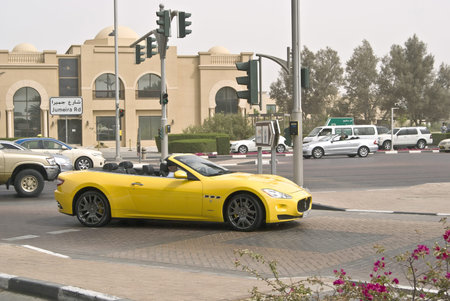 Dubai, UAE, novemner 1, 2017: man driving a yellow cabriolet Maserati carのeditorial素材