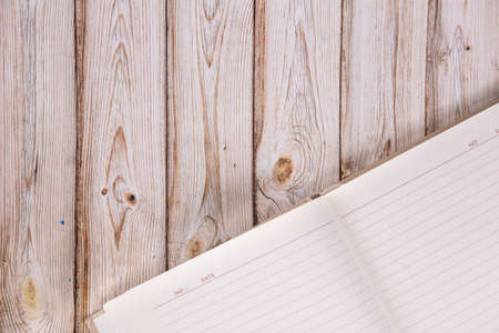 open blank notepad on a wooden background. Mockupの写真素材