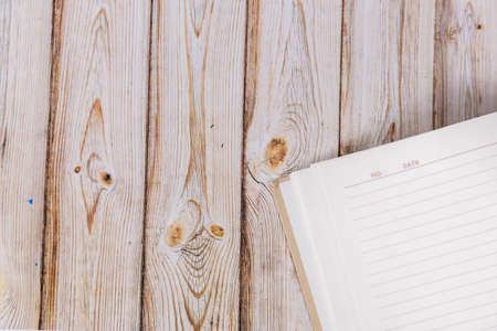 open blank notepad on a wooden background. Mockupの写真素材