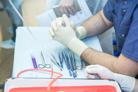 student doctor is preparing for surgery. medical instruments close-upの写真素材
