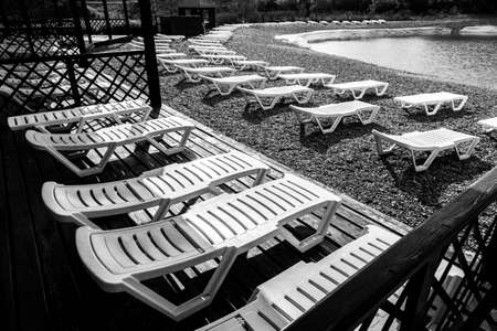 white sunbeds on the beach. Rest area on the shore.の写真素材