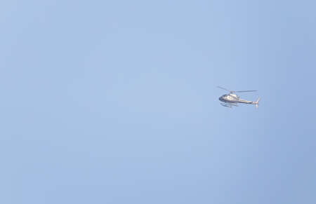 sylvery helicopter flying against the blue skyの写真素材