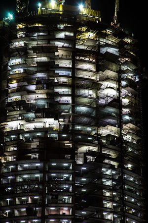 night view on under construction skyscraper. building illuminationの写真素材