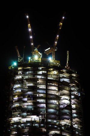 night view on under construction skyscraper. building illuminationの写真素材