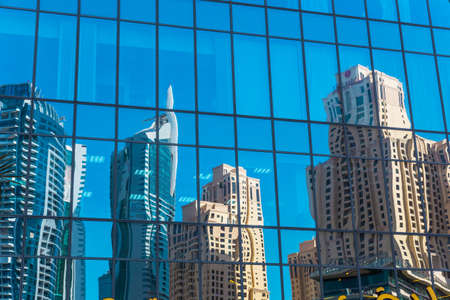 skyscrapers in reflection on blue glassの写真素材