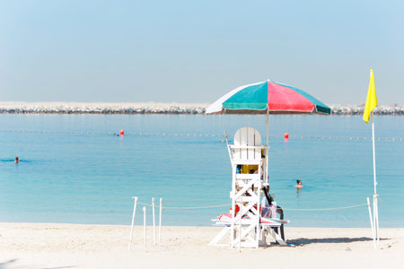 rescue station on the beach against the background of bathing people and azure water. Baywatch chairの写真素材