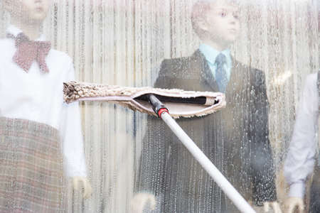 Hand washing windows with special tools and tools. Cleaning Service close upの写真素材