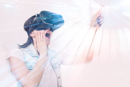 beautiful woman playing game in virtual reality glasses. complemented reality in a double exposure