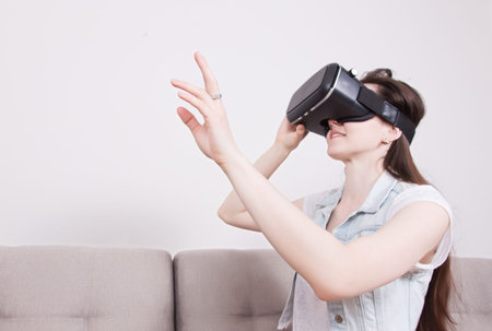 beautiful woman playing game in virtual reality glasses.