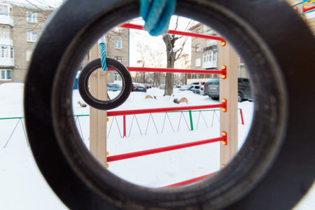Multicolored children's playground in the courtyard in the winter
