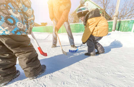 Ufa, Russia February 24, 2018: Children and adults play street hockey outdoors on a sunny winter dayのeditorial素材