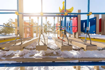Multicolored children's playground in the courtyard in the winterの写真素材